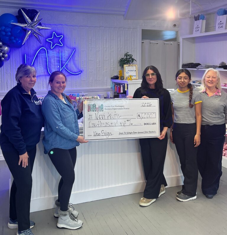Abbe Mait, owner of Novi Kids children’s clothing store receives a grant from Port Washington BID. Pictured left to right: Donna Rice, President GPWBID,  Abbe Mait, Nadine Delmonte, board member GPWBID, Holly Byrne, Executive Director, GPWBID, and Sheilly Hernadez, Senior Experience intern.